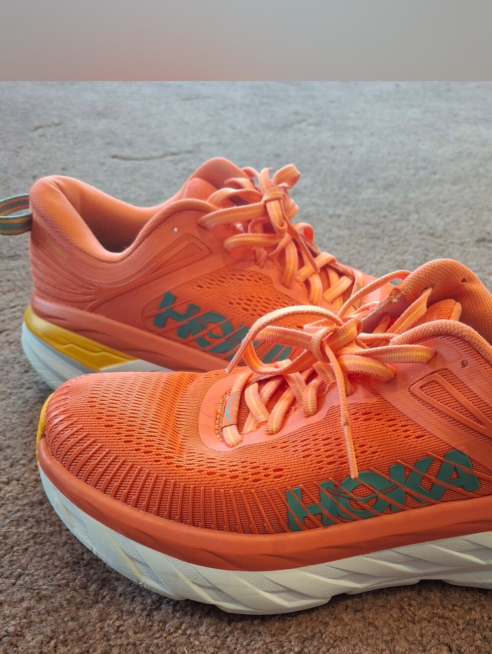 Hoka Bright Orange Running Shoes with Teal Logo